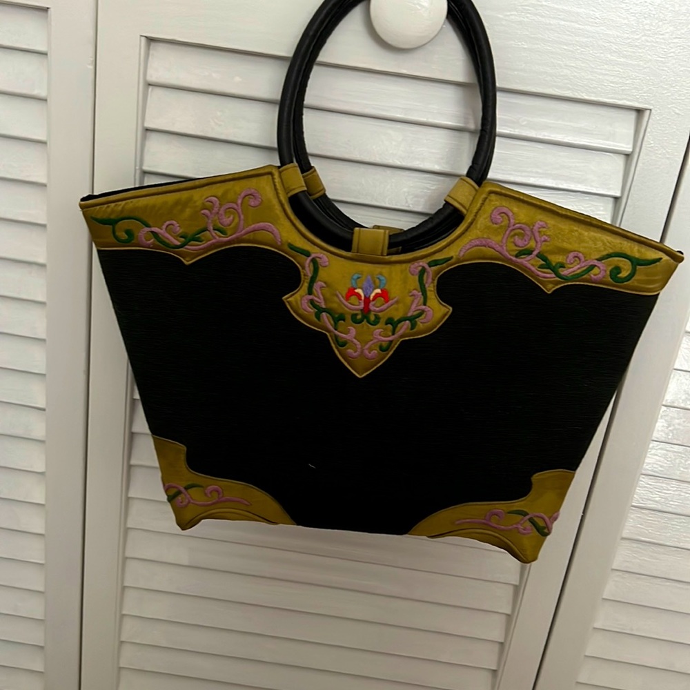 Uniquely styled handbag with satin embroidery accents